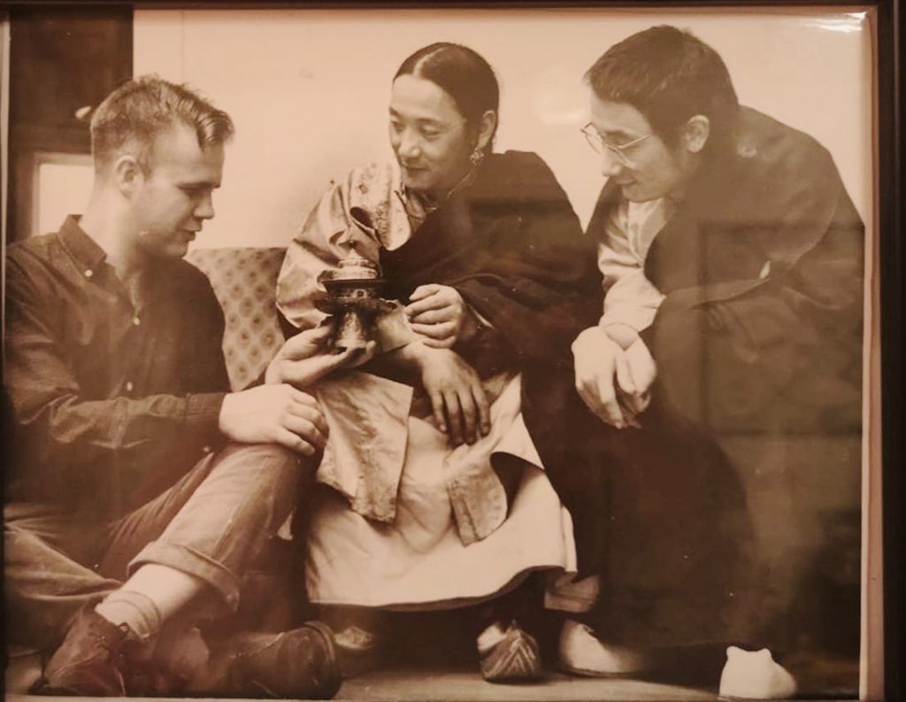 Sepia photo of Gene Smith holding a metal object with Jigdal Sakya Dagchen Rinpoche and Trinlay Rinpoche, all seated