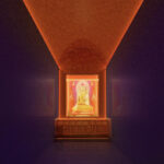 Golden Buddha statue in the center with warm red light projected above.
