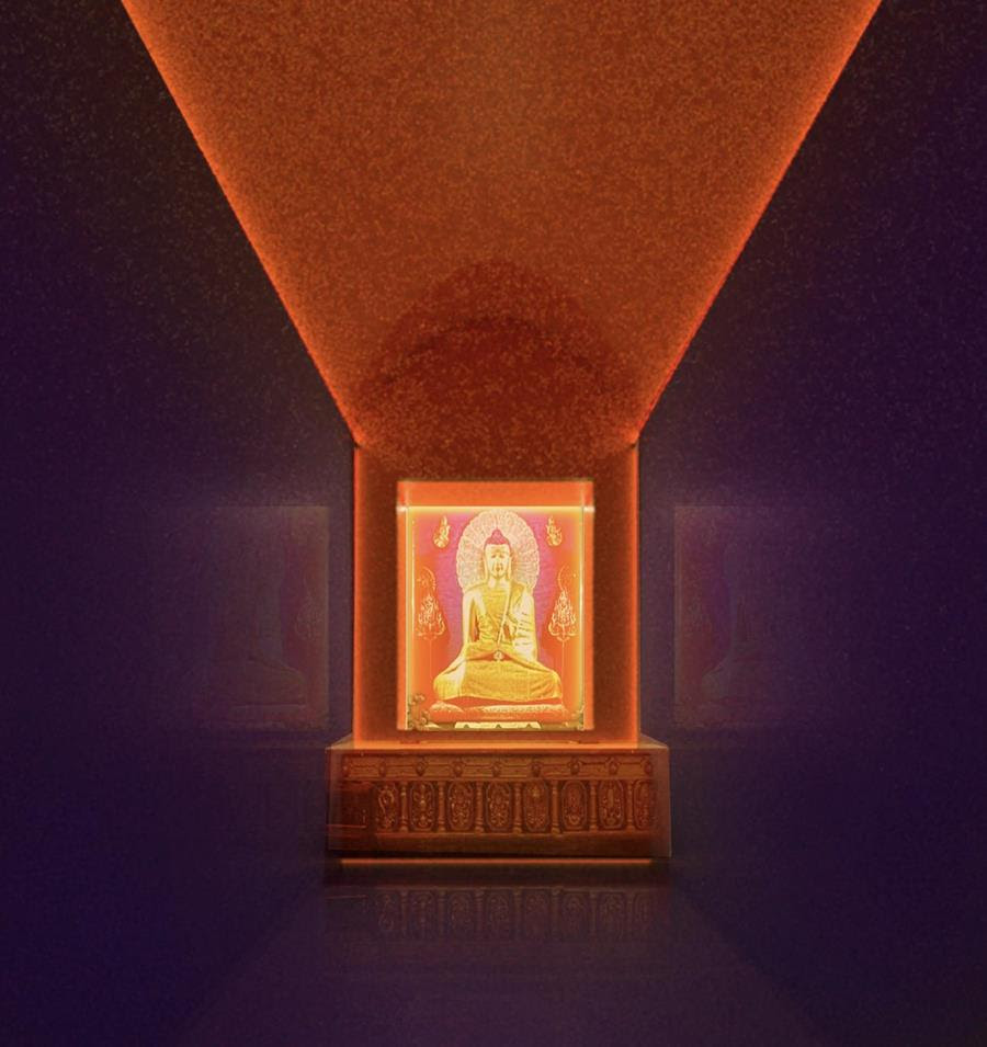 Golden Buddha statue in the center with warm red light projected above.